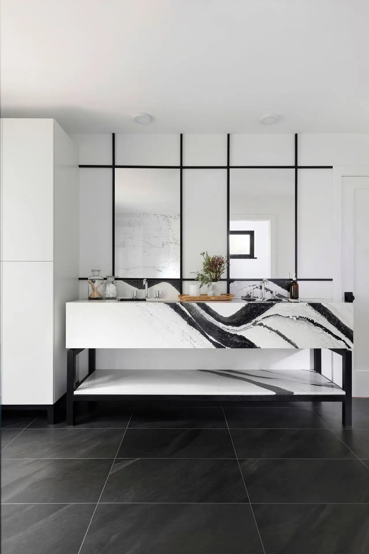 Marble bathroom vanity with dramatic black and white veining and floating design — custom countertops fabricated and installed by Signature Stone LV