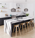Quartz kitchen island with dramatic white and gray veining and waterfall edge — elegant stone countertops installed by Signature Stone Las Vegas