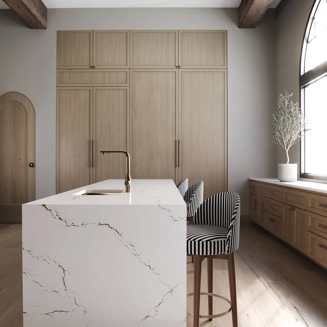 Berkshire Brass quartz kitchen island with white marble veining and waterfall edge — custom countertops fabricated and installed by Signature Stone LV