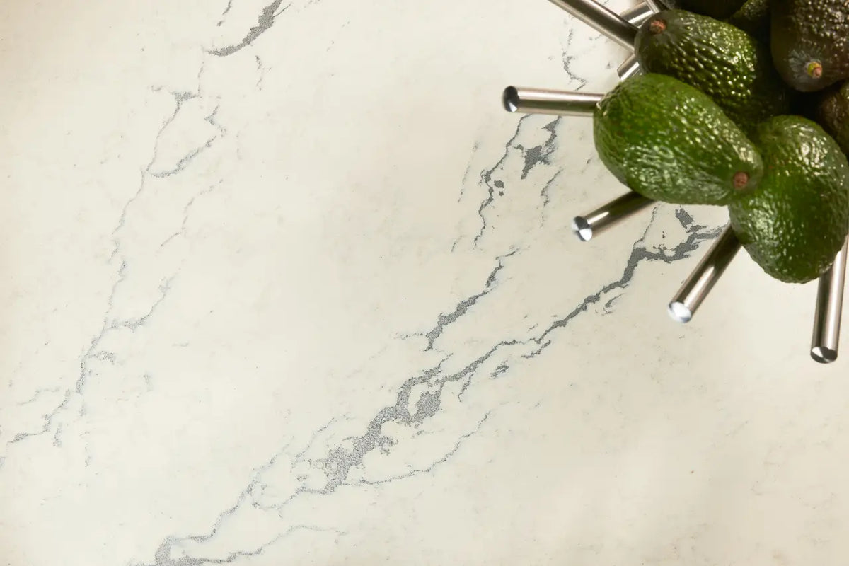 Berkshire Steel Sculpted quartz kitchen surface with white marble veining and green avocados — premium countertop fabrication by Signature Stone Las Vegas