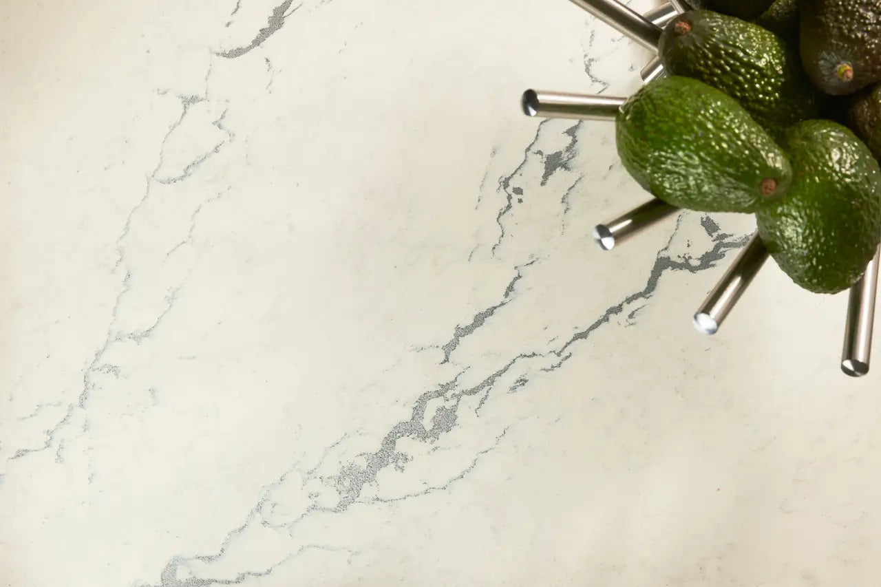 Berkshire Steel Sculpted quartz kitchen surface with white marble veining and green avocados — premium countertop fabrication by Signature Stone Las Vegas