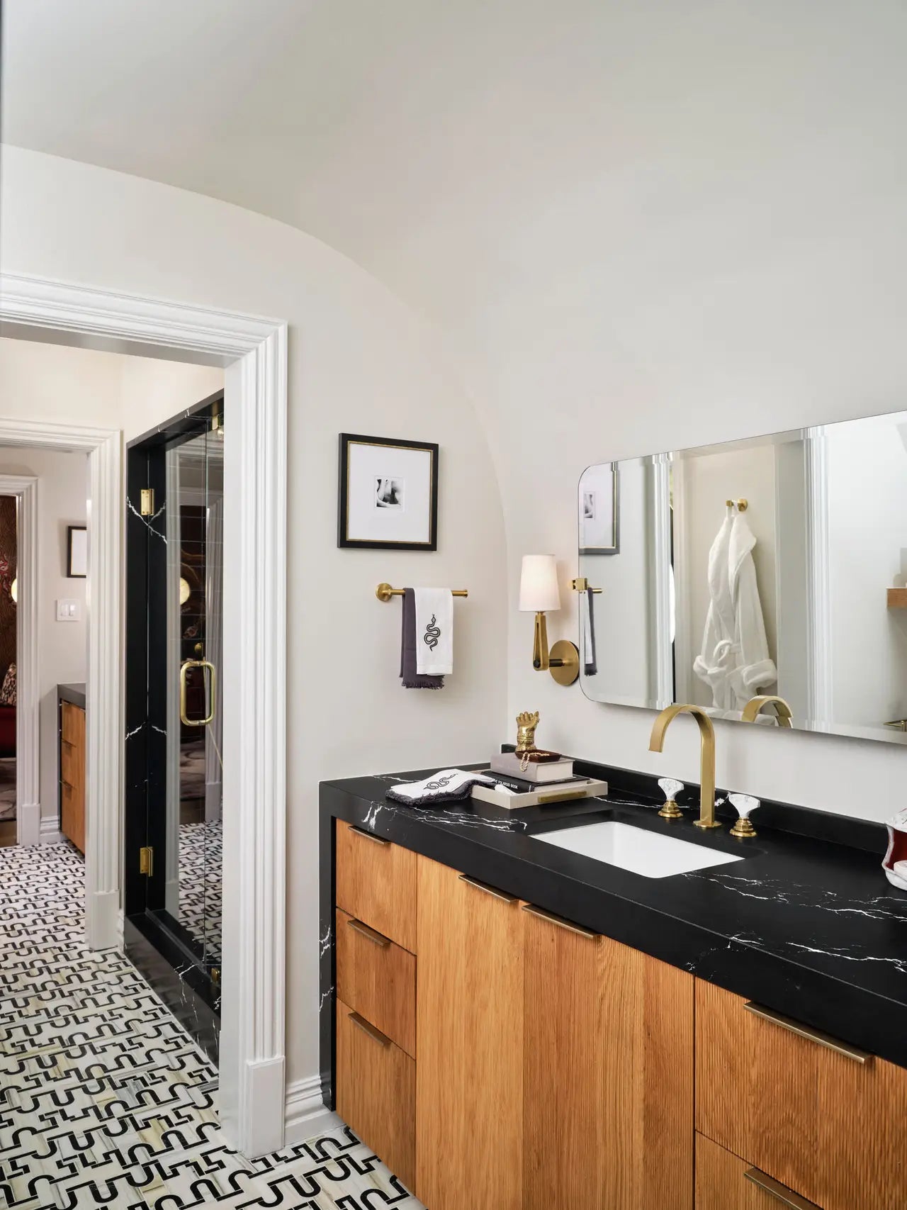 Blackbrook quartz bathroom vanity with black marble veining and gold fixtures — premium stone countertops installed by Signature Stone Las Vegas