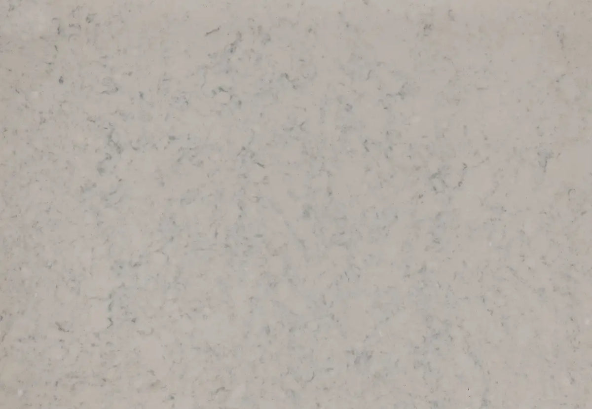Quartz surface with light beige background and subtle gray veining throughout — premium countertop fabrication by Signature Stone Las Vegas
