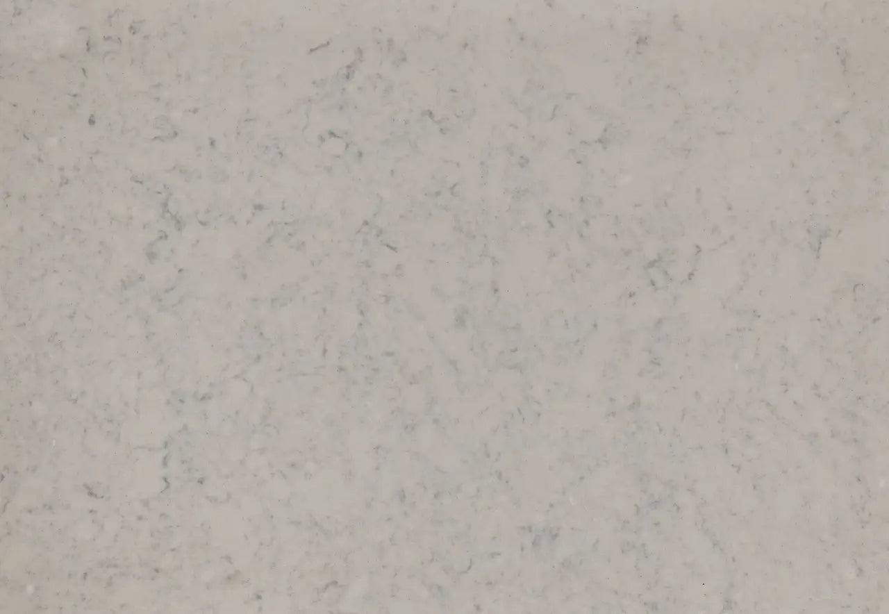 Quartz surface with light beige background and subtle gray veining throughout — premium countertop fabrication by Signature Stone Las Vegas