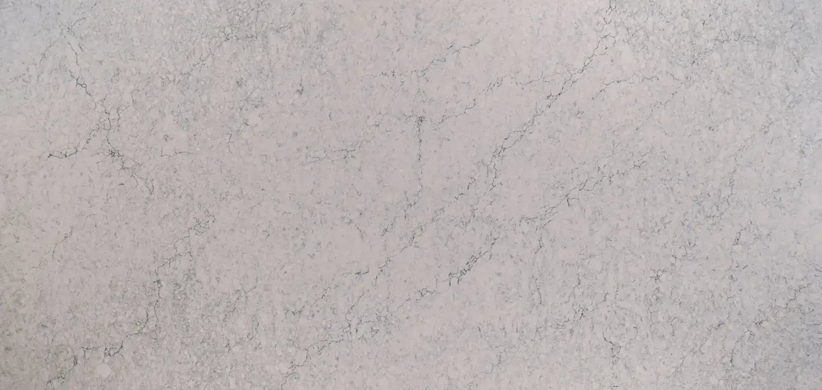 Quartz surface with light beige background and delicate gray veining patterns — premium countertop fabrication by Signature Stone Las Vegas