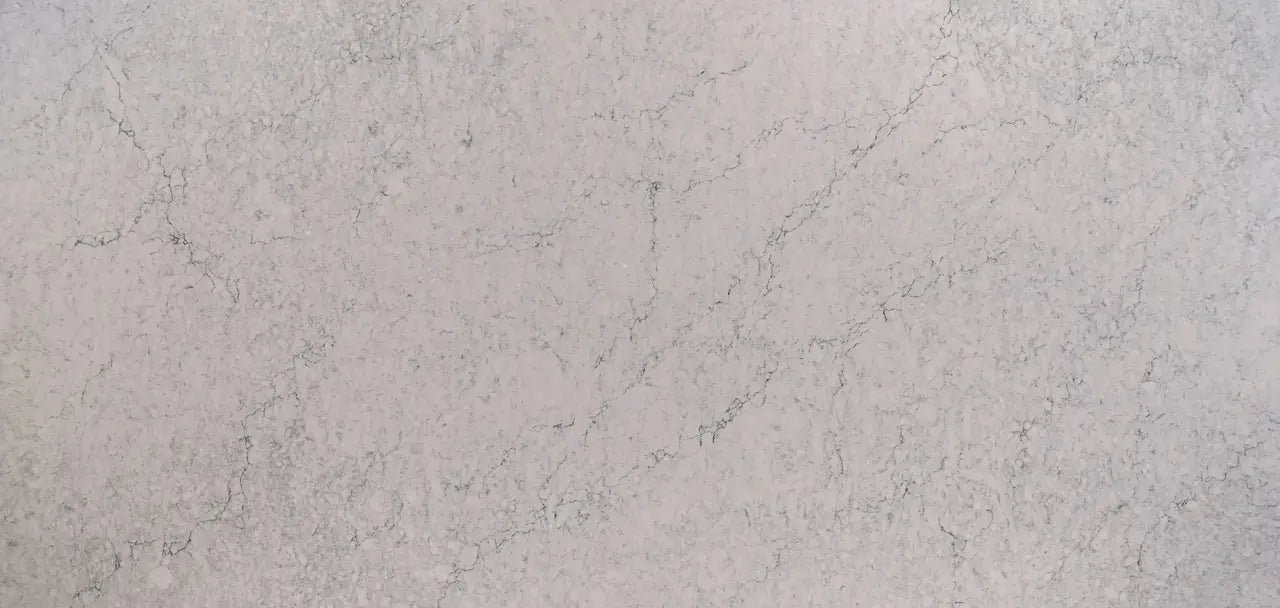 Quartz surface with light beige background and delicate gray veining patterns — premium countertop fabrication by Signature Stone Las Vegas