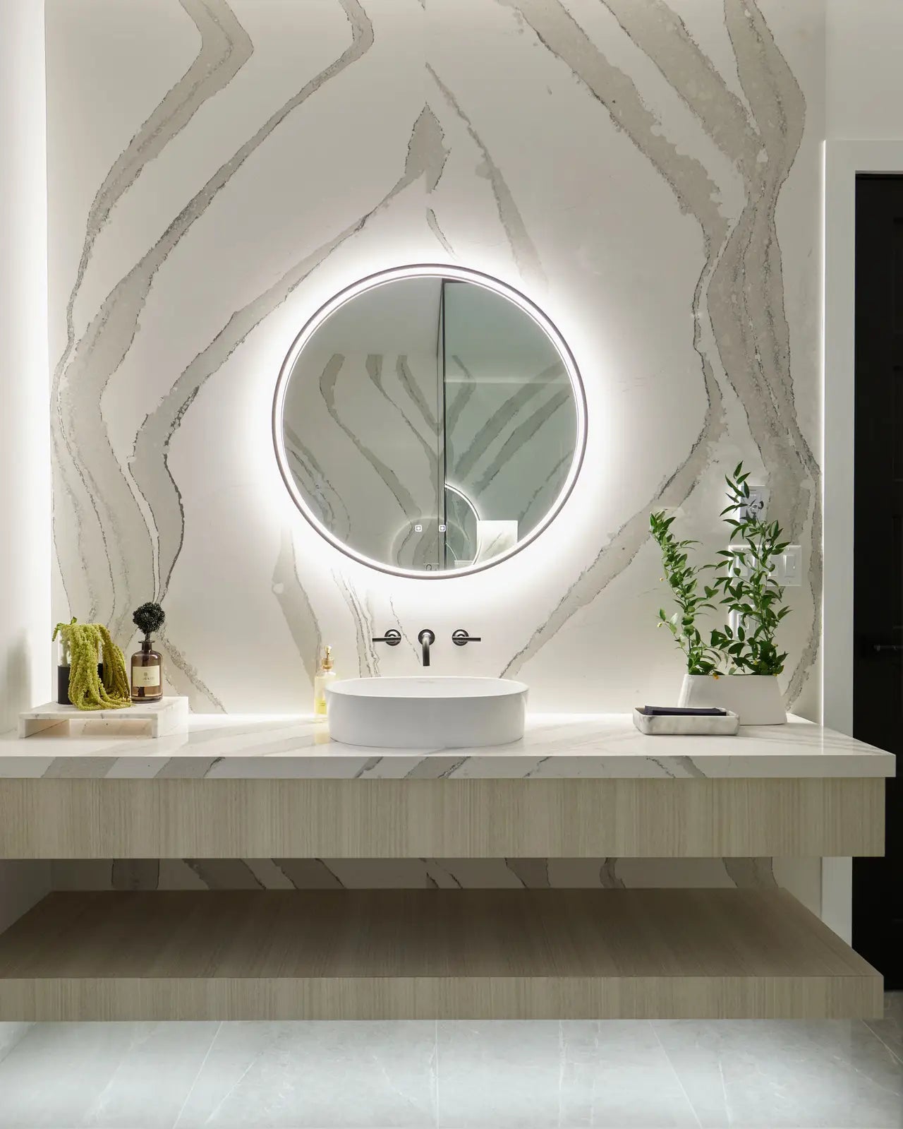 Brittanicca quartz bathroom vanity with dramatic gray veining and floating design — custom countertops fabricated and installed by Signature Stone LV