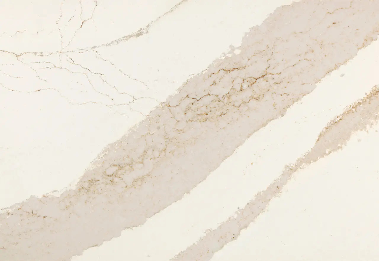 Brittanicca Gold Cool quartz slab with soft beige tones and subtle golden veining throughout the polished surface — custom countertops fabricated and install...