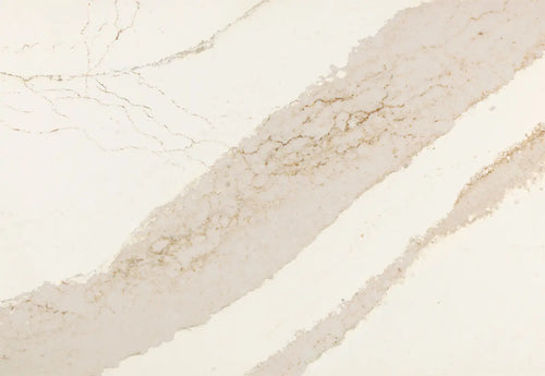 Brittanicca Gold Cool quartz slab with soft beige tones and subtle golden veining throughout the polished surface — custom countertops fabricated and install...