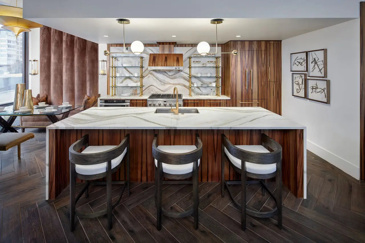 Brittanicca Gold Warm kitchen island with white marble veining and waterfall edge — custom countertops fabricated and installed by Signature Stone LV