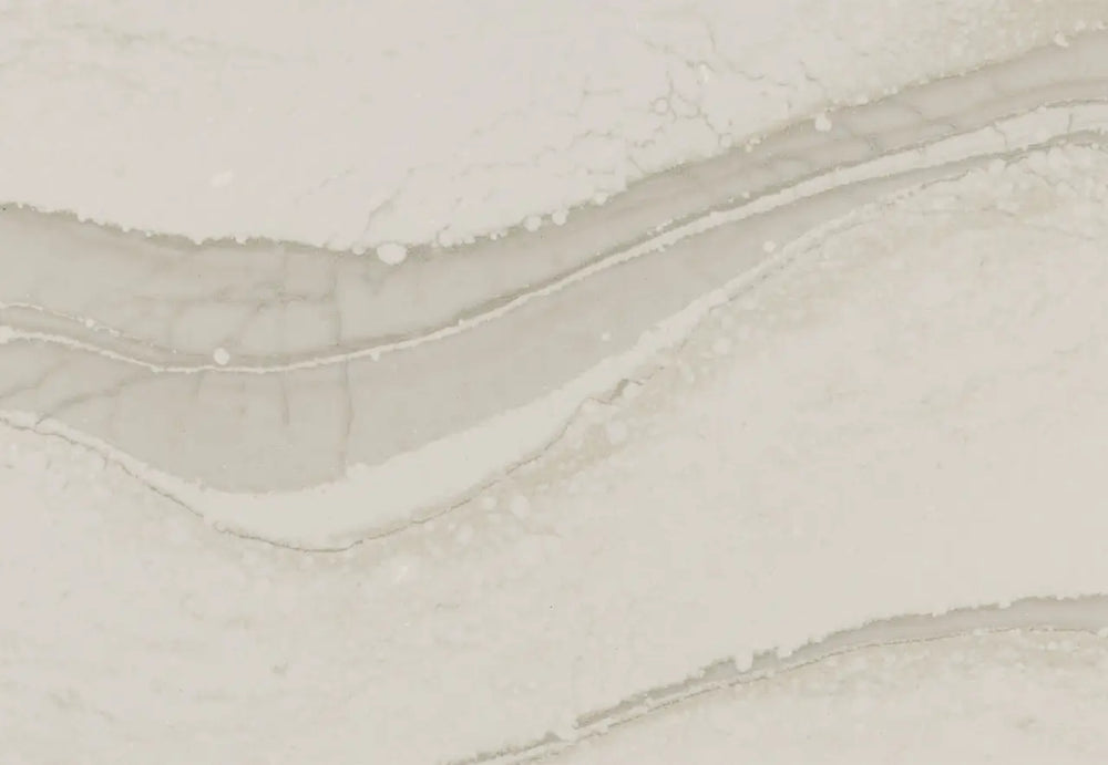 Brittanicca Warm quartz surface with flowing beige and cream veining and polished finish — custom countertops fabricated and installed by Signature Stone LV