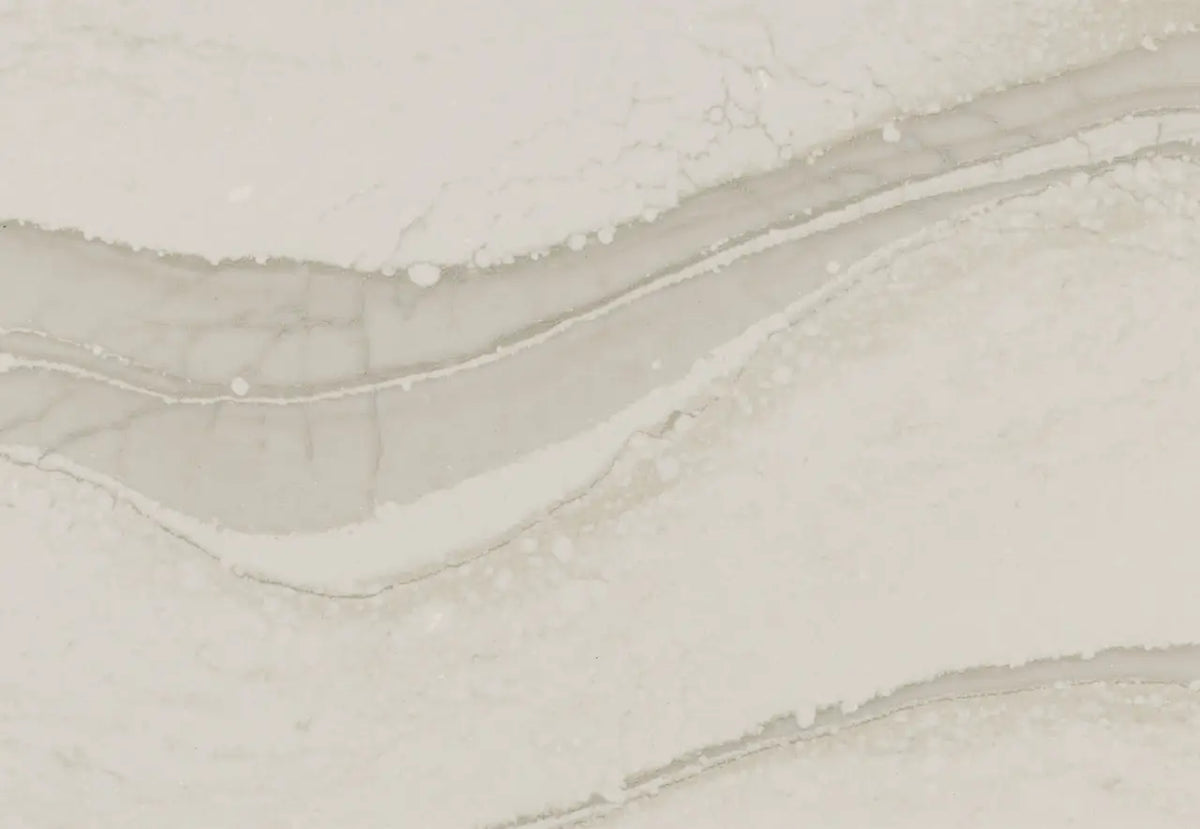 Brittanicca Warm quartz surface with flowing beige and cream veining and polished finish — custom countertops fabricated and installed by Signature Stone LV