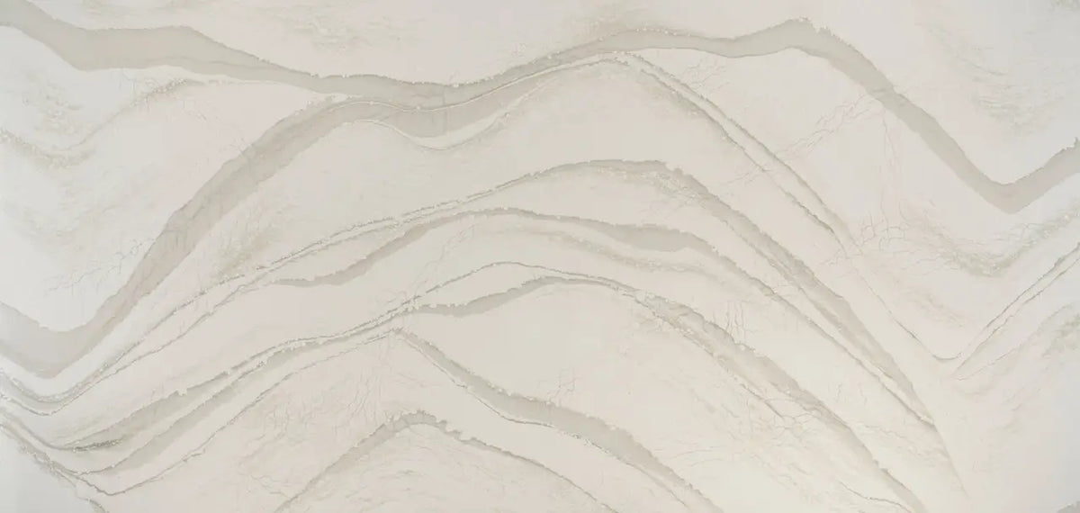 Brittanicca Warm quartz surface with flowing cream and beige veining in polished finish — custom countertops fabricated and installed by Signature Stone LV