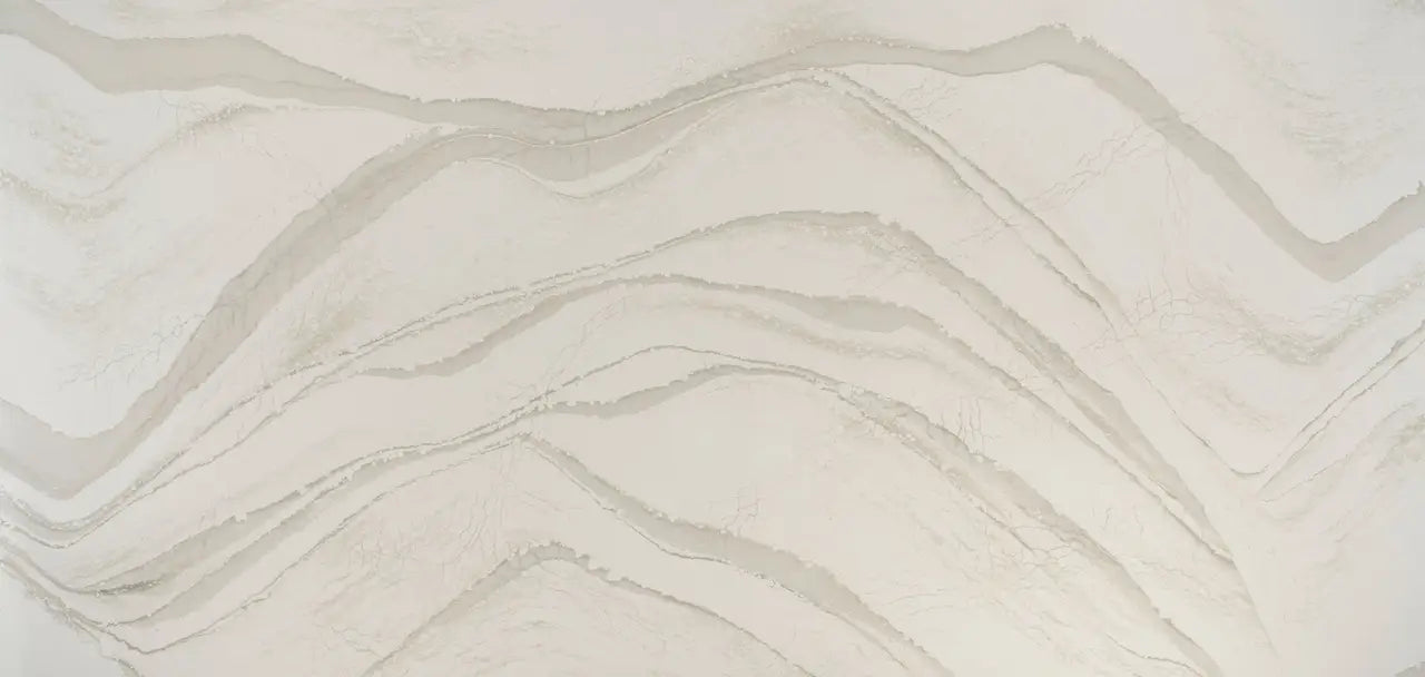 Brittanicca Warm quartz surface with flowing cream and beige veining in polished finish — custom countertops fabricated and installed by Signature Stone LV