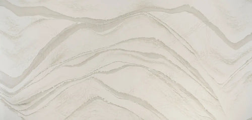 Brittanicca Warm quartz surface with flowing cream and beige veining in polished finish — custom countertops fabricated and installed by Signature Stone LV