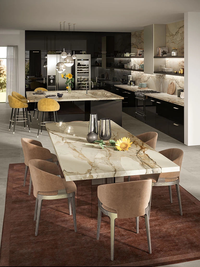 Calacatta Antique marble kitchen island and dining table with white and gold veining — luxury stone countertops installed by Signature Stone Las Vegas