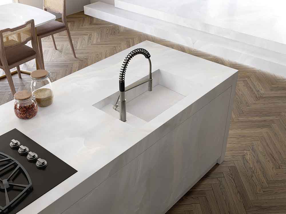 Chamonix quartz kitchen island with integrated sink and sleek white finish — premium stone countertops installed by Signature Stone Las Vegas