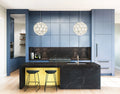 Dark marble kitchen island with white veining and gold base accents — premium stone countertops installed by Signature Stone Las Vegas
