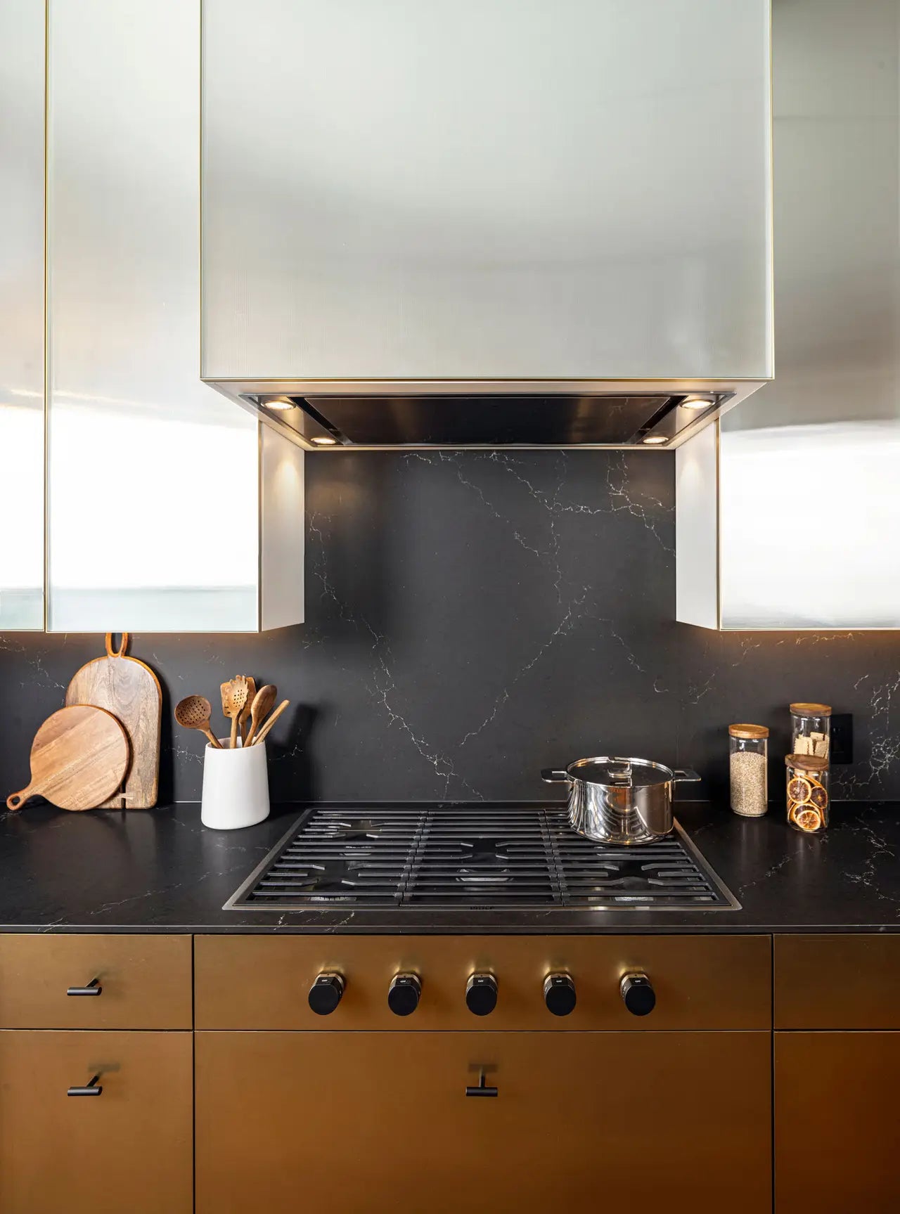 Quartz kitchen countertops with dark veined surface and warm wood cabinetry — expert countertop fabrication by Signature Stone Las Vegas