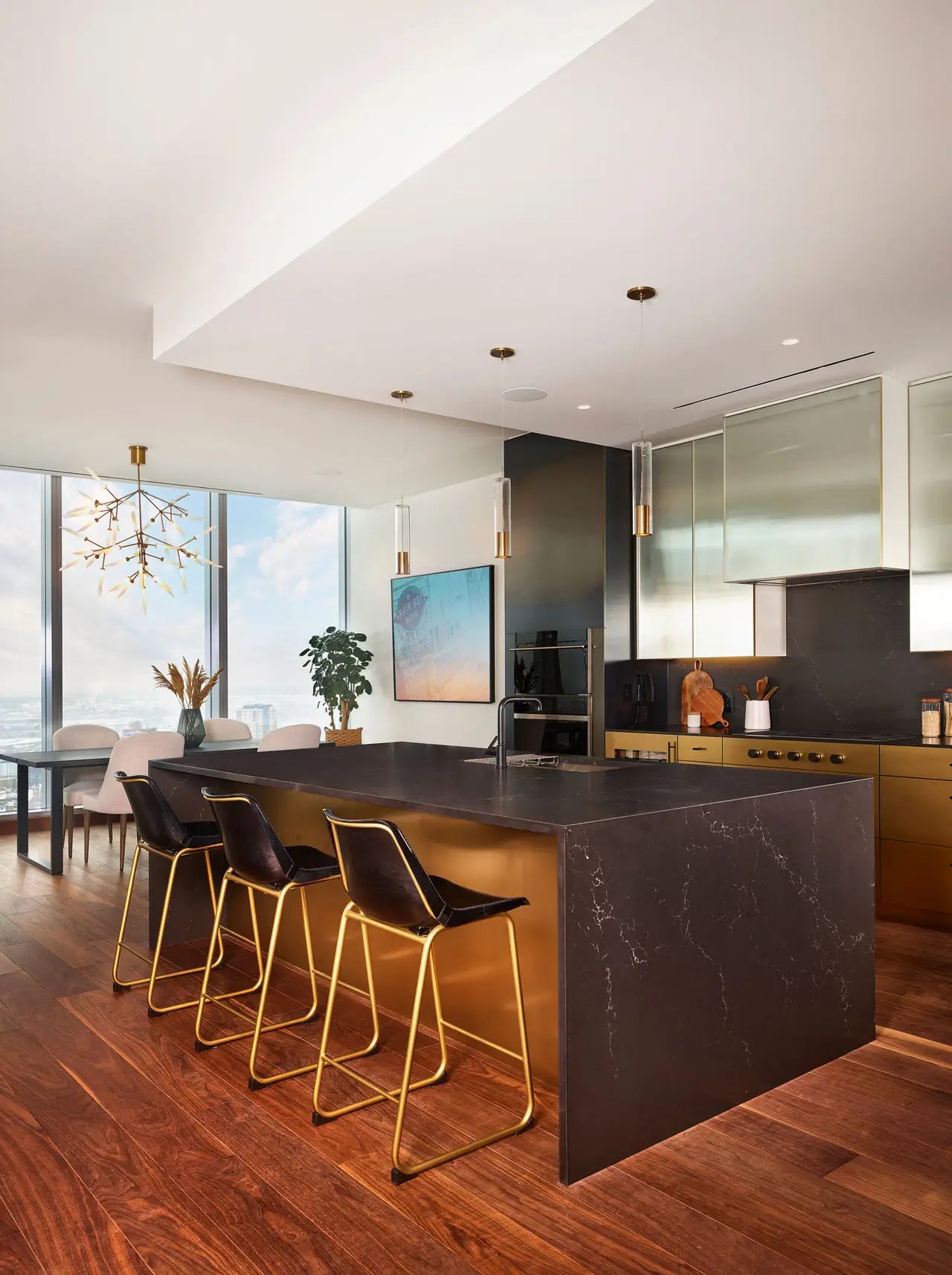 Quartz kitchen island with dark veined surface and waterfall edge — modern stone countertops installed by Signature Stone Las Vegas