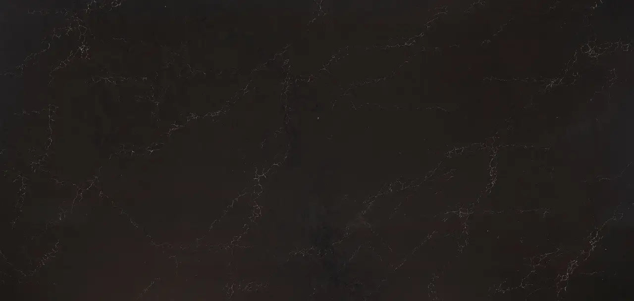 Dark quartz surface with subtle golden veining and polished finish — premium countertop fabrication by Signature Stone Las Vegas