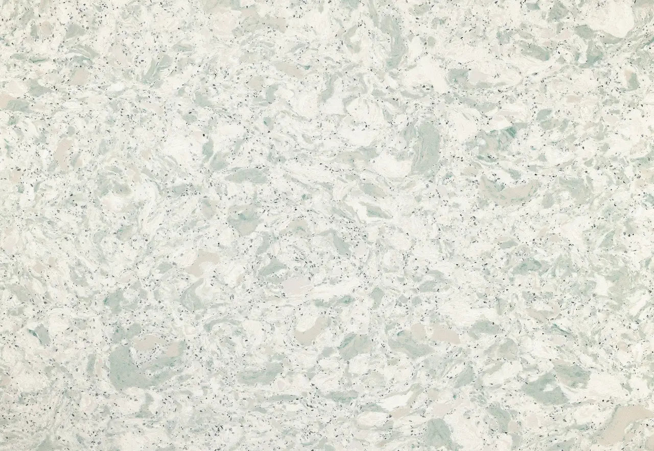 Quartz surface with soft sage green and cream veining throughout speckled white base — custom countertops fabricated and installed by Signature Stone LV