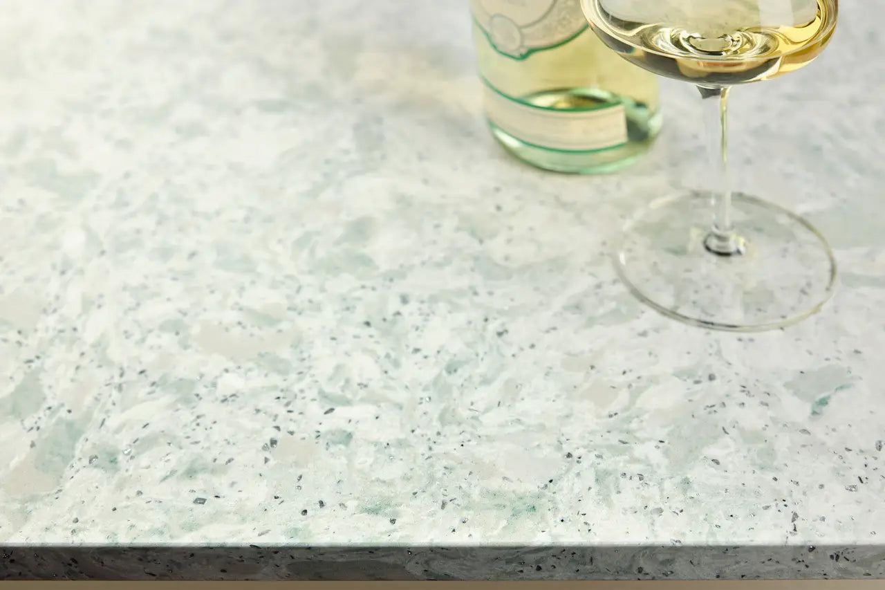 Quartz kitchen countertop with white and green speckled pattern and polished finish — custom countertops fabricated and installed by Signature Stone LV