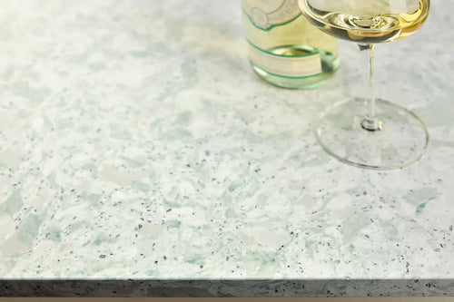 Quartz kitchen countertop with white and green speckled pattern and polished finish — custom countertops fabricated and installed by Signature Stone LV