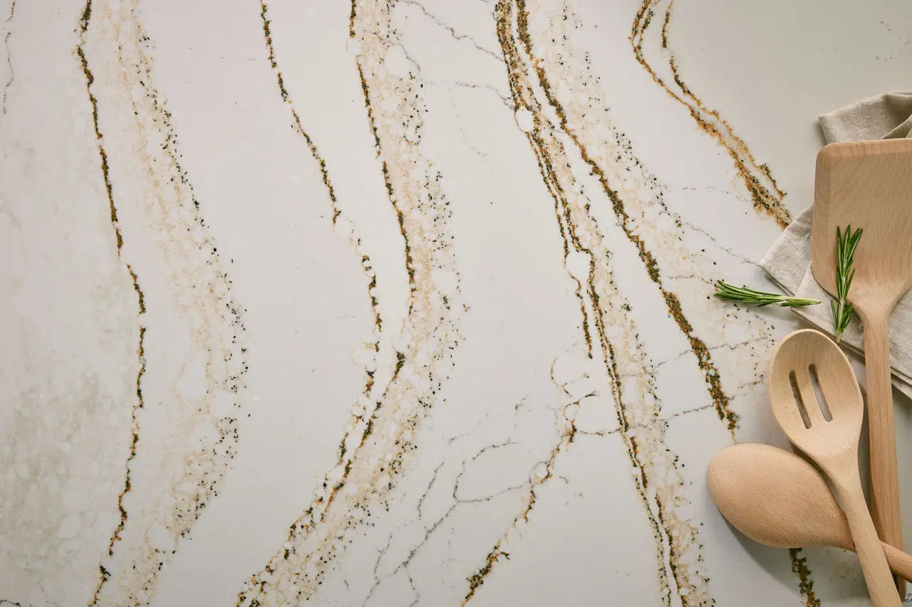 Clovelly quartz surface with elegant white base and golden veining — custom countertops fabricated and installed by Signature Stone LV