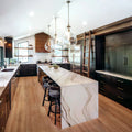 Calacatta quartz kitchen island with dramatic white veining and waterfall edge — premium stone countertops installed by Signature Stone Las Vegas