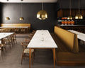 Marble restaurant tables with white surfaces and wood legs in modern dining room — premium stone countertops installed by Signature Stone Las Vegas
