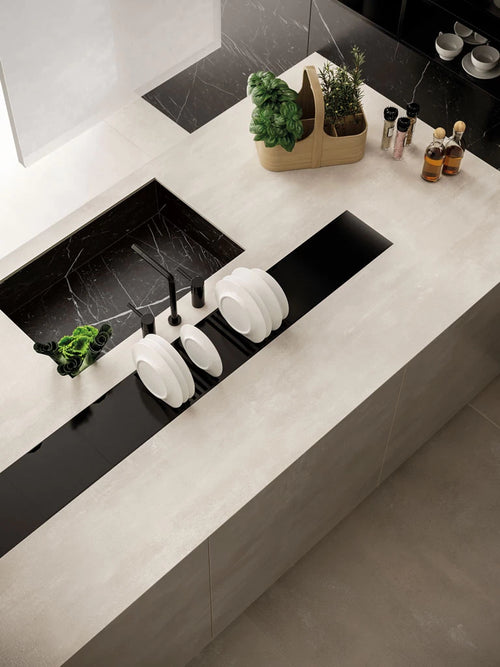 Boost White quartz kitchen countertops with black marble-look backsplash and integrated sink — premium stone countertops installed by Signature Stone Las Vegas
