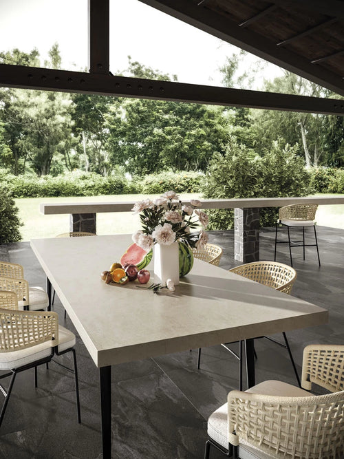 Cream Prestige outdoor dining table with smooth light surface — elegant stone countertops installed by Signature Stone Las Vegas