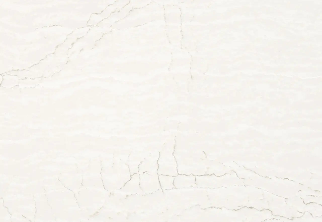 Delgatie quartz surface featuring soft white background with subtle gray veining and polished finish — custom countertops fabricated and installed by Signatu...