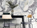 Dover White quartz dining table with dramatic gray marble wall backdrop — elegant stone countertops installed by Signature Stone Las Vegas