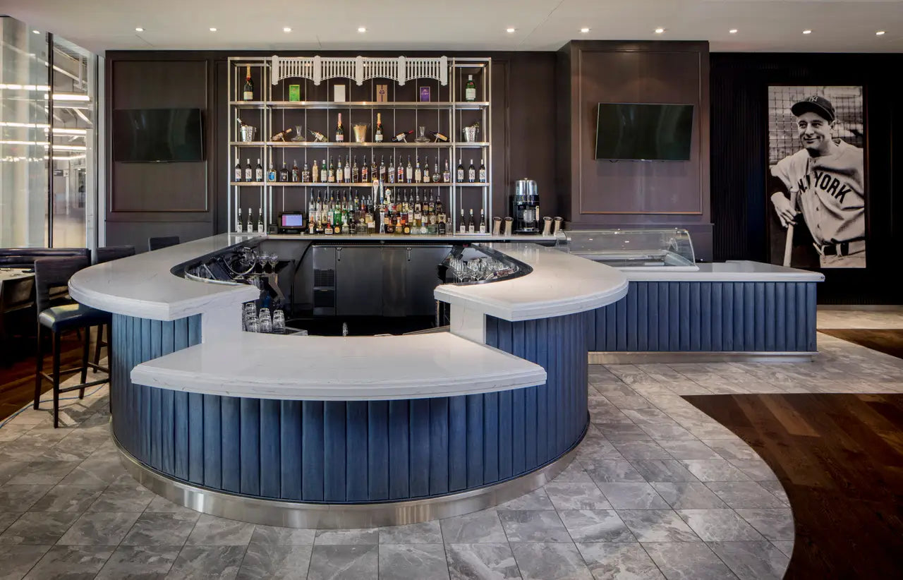 Marble curved bar countertops with white veining and polished finish in luxury home bar — premium countertop fabrication by Signature Stone Las Vegas