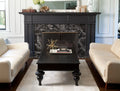 Natural stone fireplace surround with dark veined marble pattern and black mantel — elegant stone countertops installed by Signature Stone Las Vegas