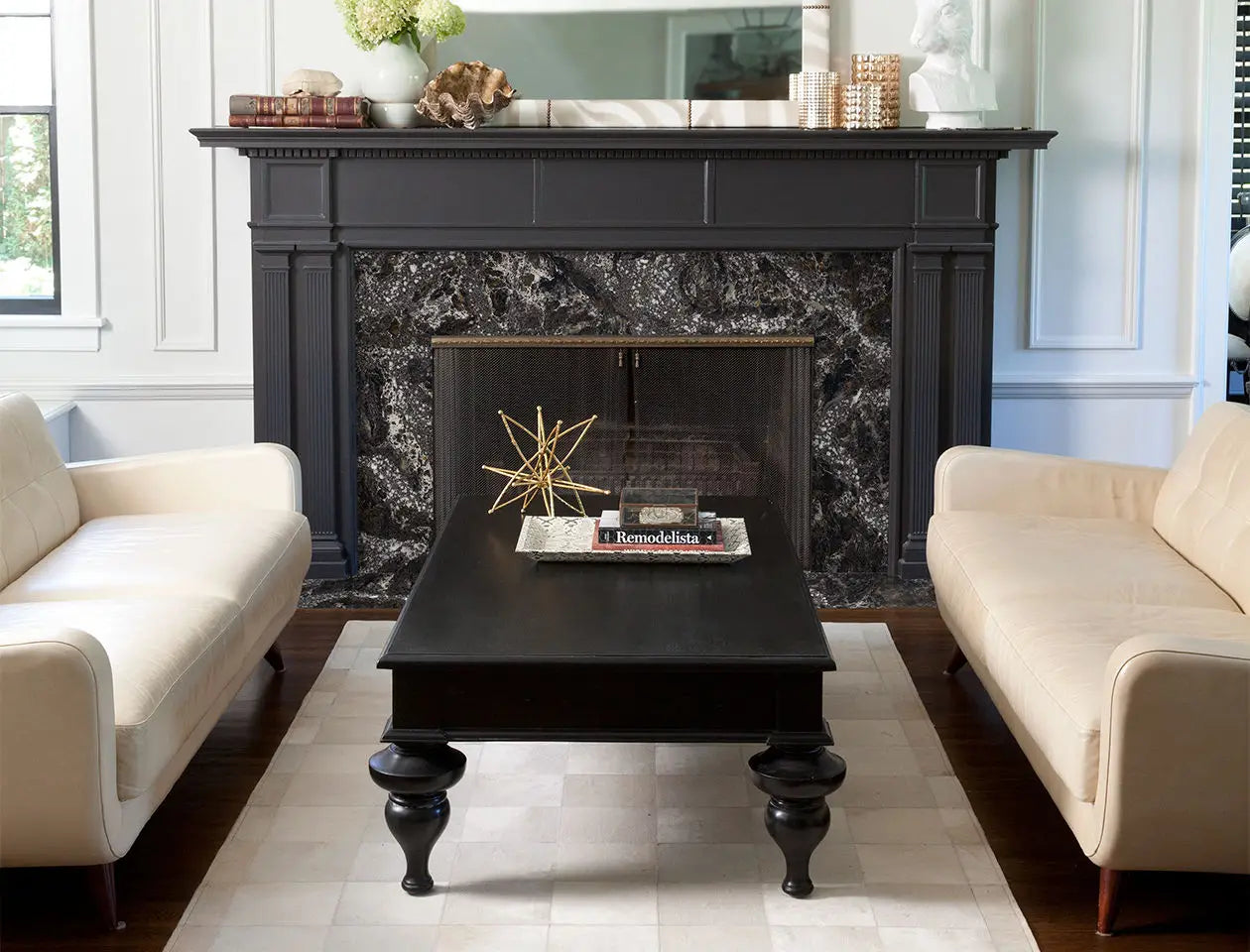 Natural stone fireplace surround with dark veined marble pattern and black mantel — elegant stone countertops installed by Signature Stone Las Vegas
