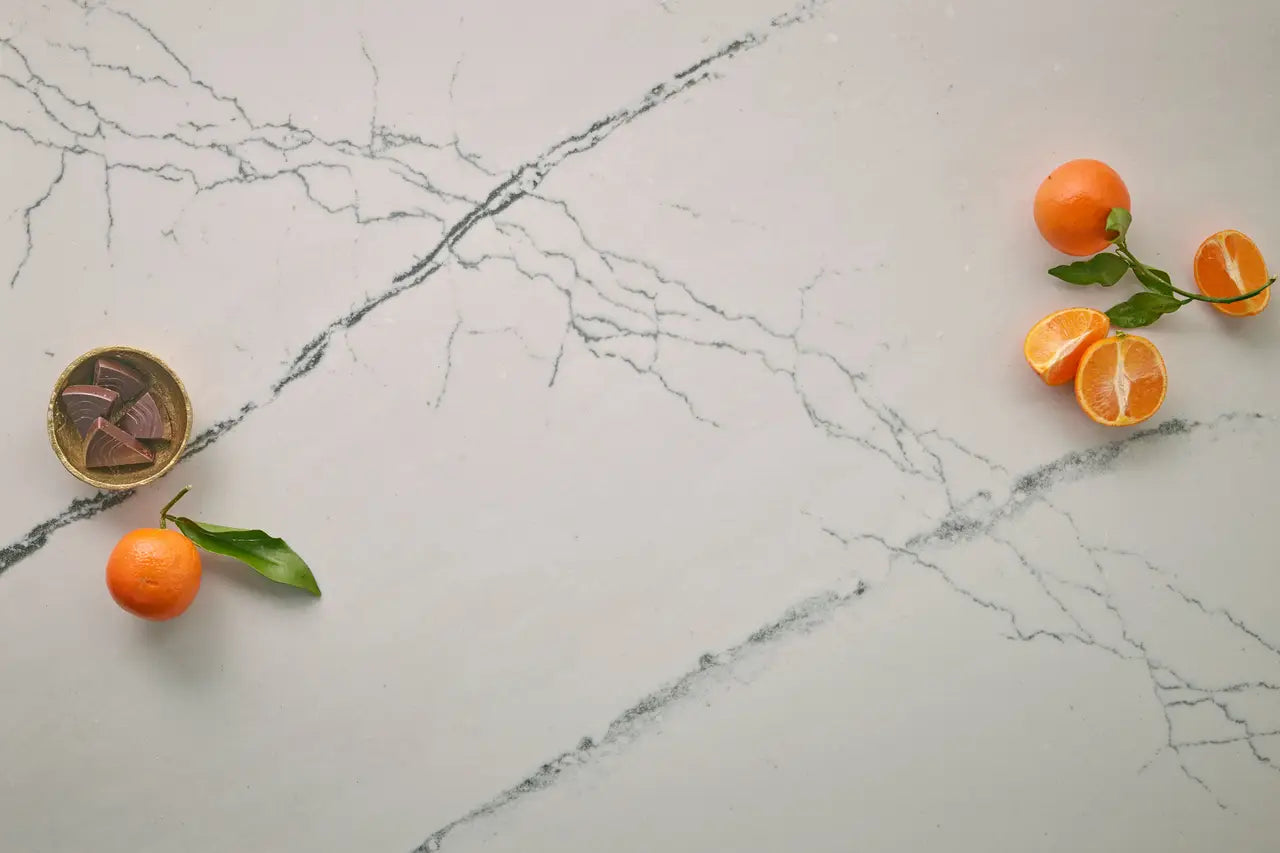 Marble countertop surface with gray veining and orange citrus display — premium countertop fabrication by Signature Stone Las Vegas