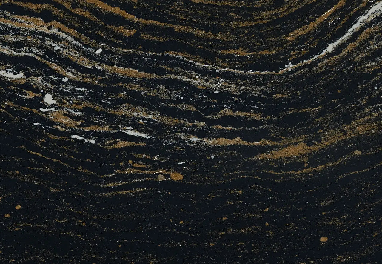 Black and gold granite countertop surface with wavy, natural veining pattern