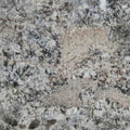 Granite slab with ash blue, grey, and beige speckled countertop surface