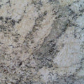 Granite Snowfall slab with creamy white base and gray mineral veining, ideal for countertops