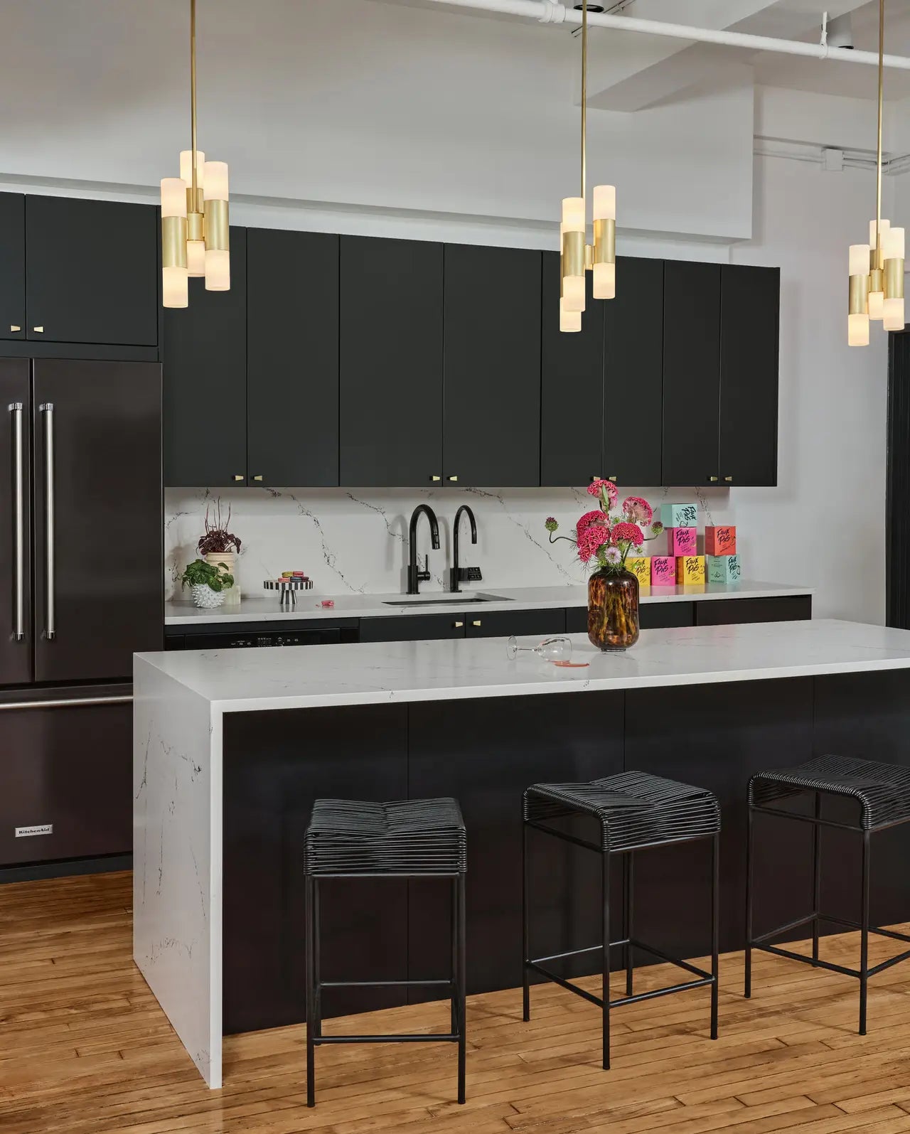 Quartz kitchen island and countertops with white marble veining and waterfall edge — expert countertop fabrication by Signature Stone Las Vegas