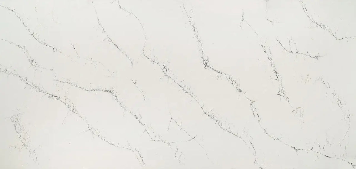 Quartz slab surface with light gray background and subtle dark veining — premium countertop fabrication by Signature Stone Las Vegas