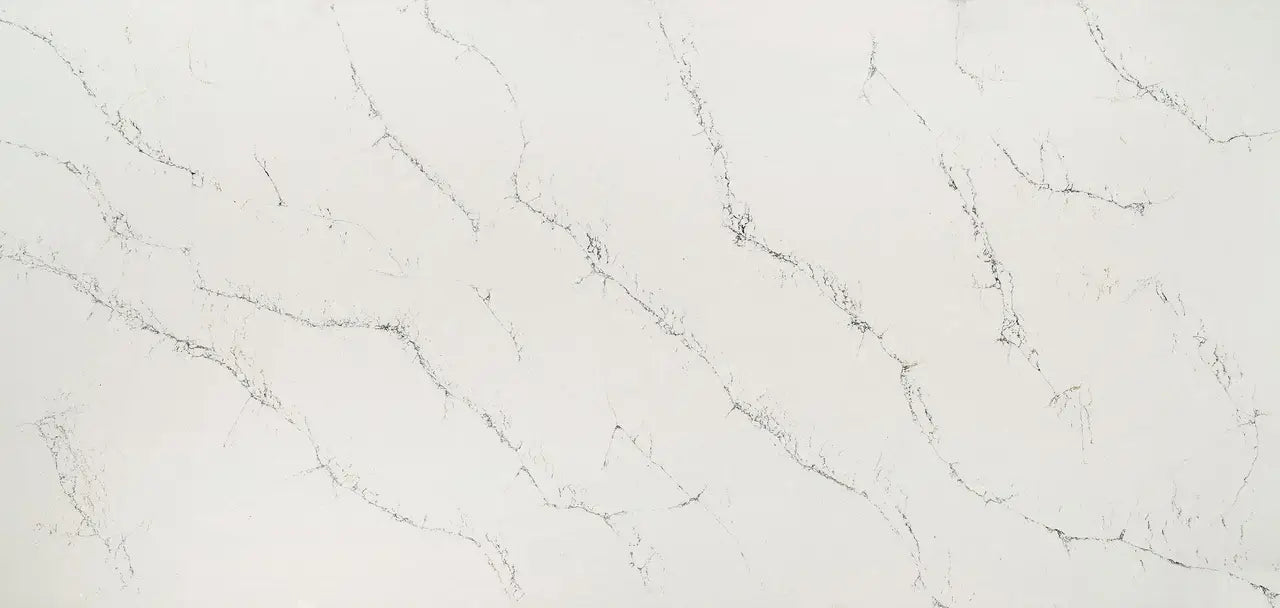 Quartz slab surface with light gray background and subtle dark veining — premium countertop fabrication by Signature Stone Las Vegas