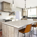 White quartz kitchen island and perimeter countertops with light veining and clean edges — premium stone countertops installed by Signature Stone Las Vegas