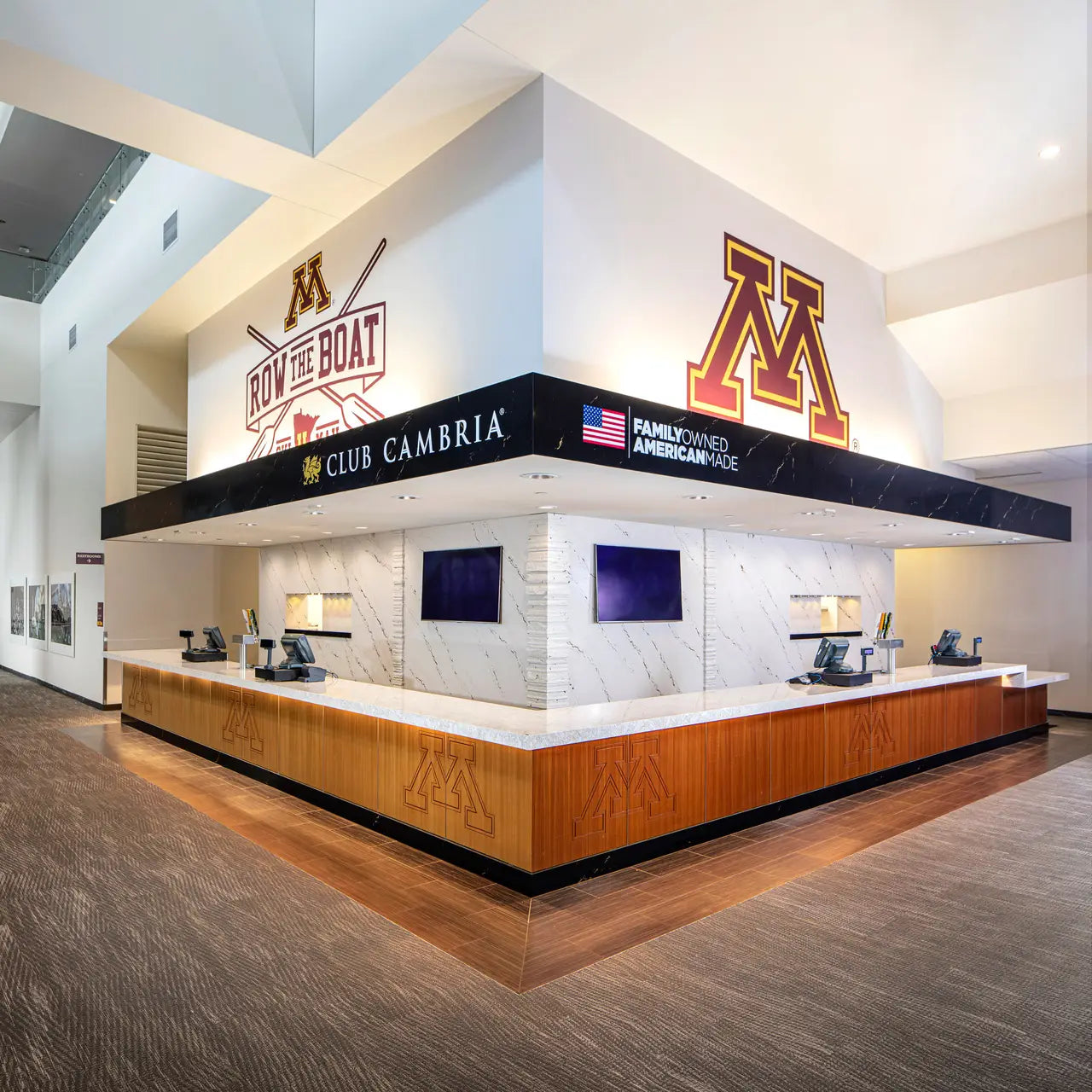 Hermitage stone reception desk surfaces with white marble patterns and warm wood base — custom countertops fabricated and installed by Signature Stone LV