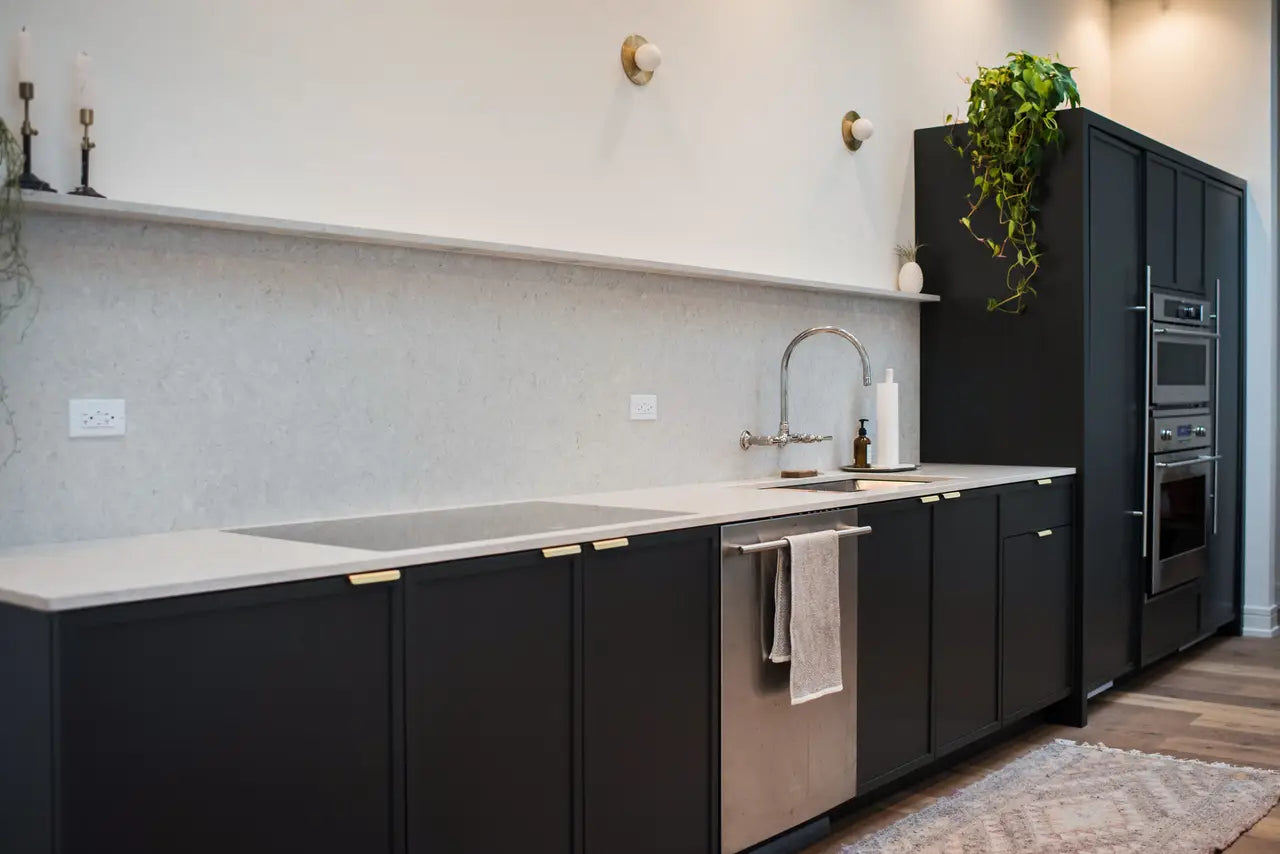 Quartz kitchen countertops with white surface and straight edges in modern black cabinetry — premium stone countertops installed by Signature Stone Las Vegas
