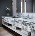 Dramatic veined marble double vanity with waterfall edge and black faucets — luxurious stone countertops installed by Signature Stone Las Vegas