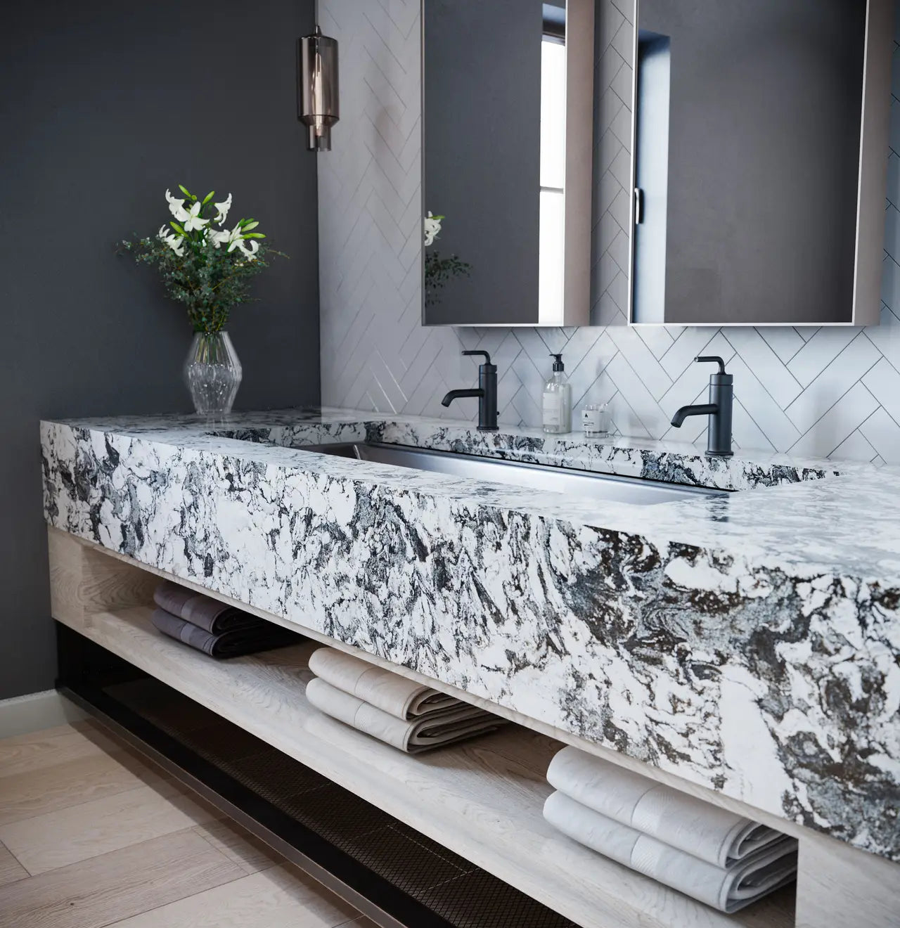Dramatic veined marble double vanity with waterfall edge and black faucets — luxurious stone countertops installed by Signature Stone Las Vegas